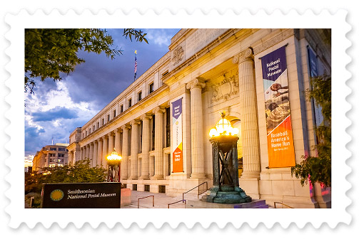 A colorful photograph of the National Postal Museum building against an evening sky backdrop.