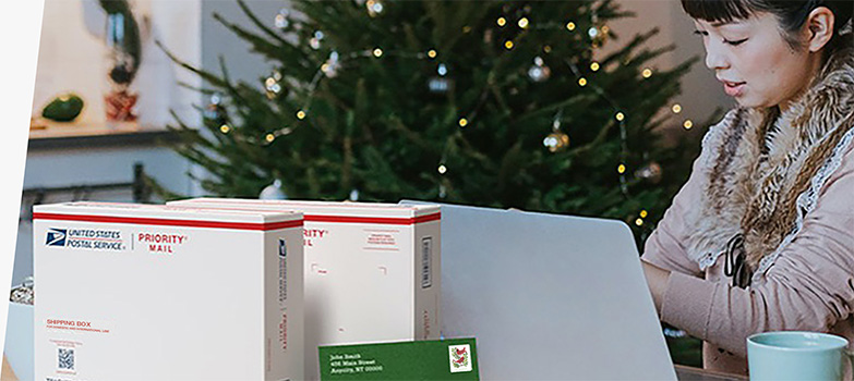 A woman preparing to ship holiday gifts with a Priority Mail Express box and a Priority Mail box.